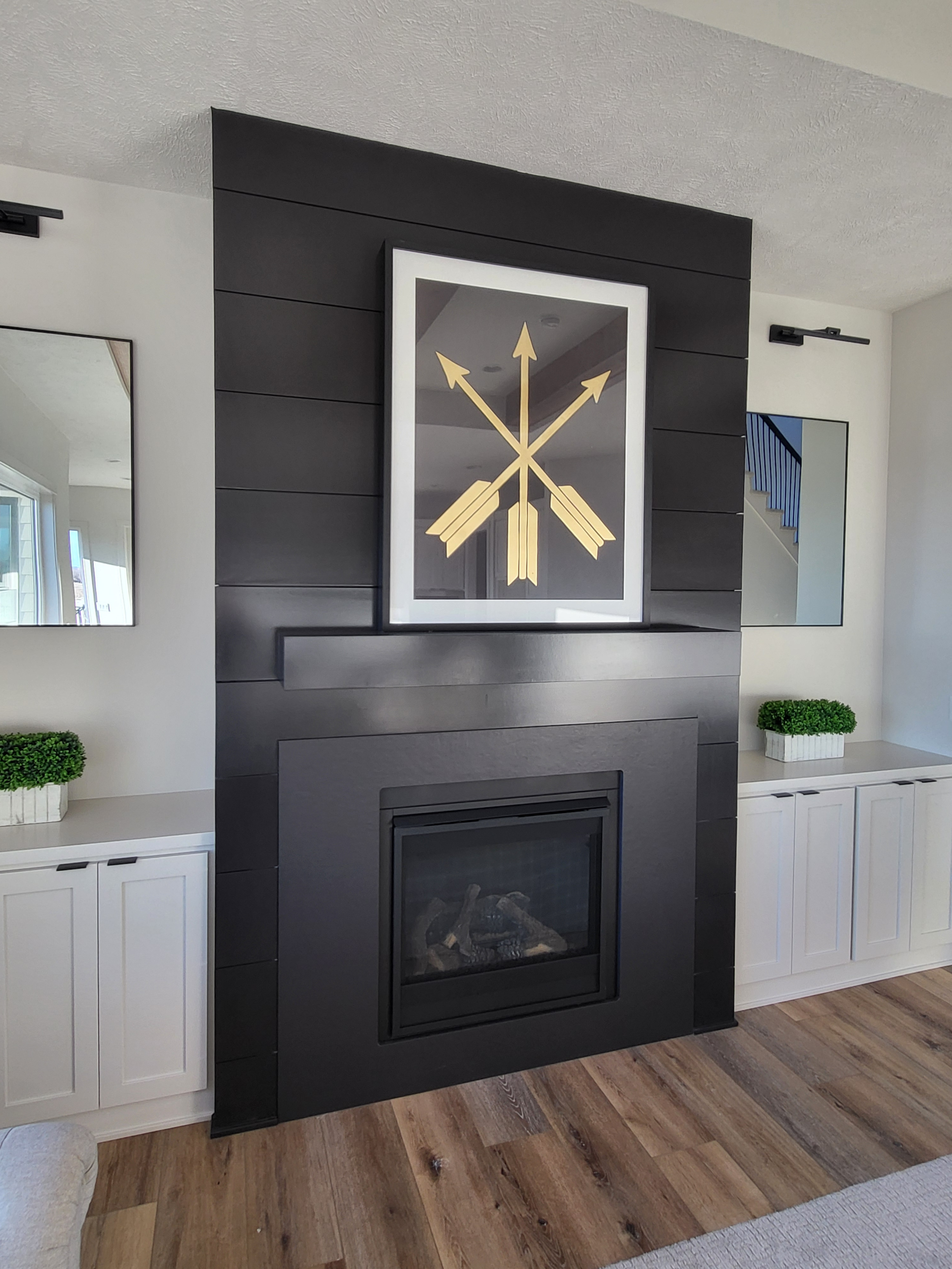 install shiplap — large living room with wide black shiplap feature wall and custom cabinetry