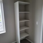 Face-frame closet shelving unit with five shelves and white finished frame, ready for paint.