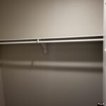 Closet opening with jamb, casing, and hanging rod installed; ready for bi-fold or bypass doors.