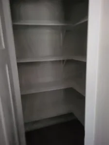 Closet corner with multiple shelves installed along the back wall