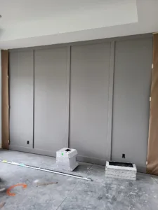 Four panel bypass doors painted gray, installed in a closet opening with recessed pulls