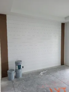 Unfinished horizontal shiplap wall with reveal gaps between boards, ready for paint