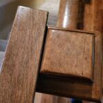 Stained wood molding detail showing profile and finish quality on trim pieces.