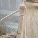 Iron baluster railing Step 1: drilled holes in stair treads and newel post with handrail installed, ready for paint before balusters are set.
