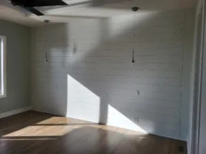 Painted light gray horizontal shiplap wall with reveal gaps and pendant lighting