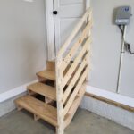 Three-step stair with open risers and horizontal-rod railing, raw wood ready for finish.