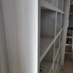 Face-frame closet shelving unit with multiple shelves, primed and painted white, ready for hardware and final finishing.