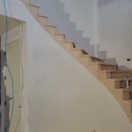 Open staircase with finished wood risers and treads, raw wood ready for paint or stain.