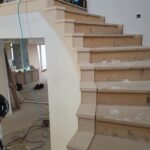 Finished stair treads and risers installed with raw wood, ready for paint or stain.