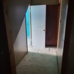 Two interior doors installed in hallway with white primed and dark stained finishes, jambs and casing visible.