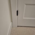 This photo shows a completed pocket door installation with a clean finish and proper alignment, highlighting the door's hardware and trim details.