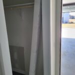 Closet rod and bracket installation in progress with drywall ready for finishing.
