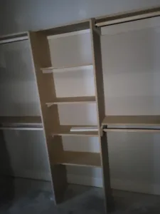 Closet shelving with multiple horizontal shelves and vertical supports, unfinished