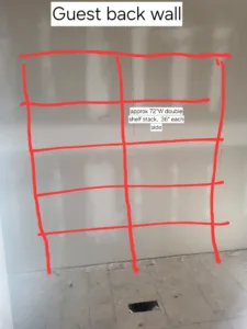 Layout marking on a bedroom wall for a double shelf stack installation, before construction