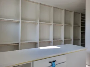 Large built-in closet shelving grid with many square compartments, fully painted and finished.