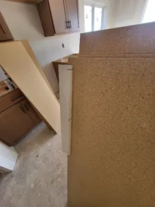 Countertop material staged in kitchen during cabinet and countertop installation phase
