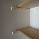 Two-shelf closet unit with particle-board bullnose shelving and 1x4 wood cleats, ready for paint.