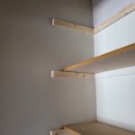 Three-shelf closet unit with 1x4 cleats and particle board shelving, raw wood finish ready for paint.