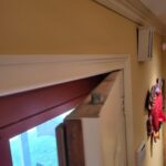This photo shows a completed pocket door installation with visible trim details, highlighting the craftsmanship and fit of the door within the frame.