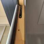 Pocket door jamb with recessed finger pull and mounting hardware holes, ready for paint.