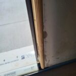 Door jamb detail during trim installation showing raw wood edge and construction-phase conditions.