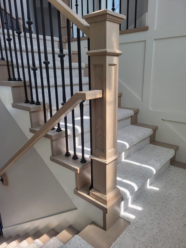 Elegant wooden handrail and baluster installation on a staircase.