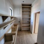 Custom built-in bookcase and shelving cabinetry installed in raw wood, ready for paint or stain.