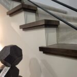 This photo shows a close-up of finished wood nosing on stairs, highlighting the clean edges and craftsmanship of the installation.
