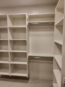 Finished closet shelving with cubbies, open shelves, and a hanging rod installed