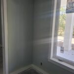 Finished trim and casing installed around window and door openings, ready for paint.