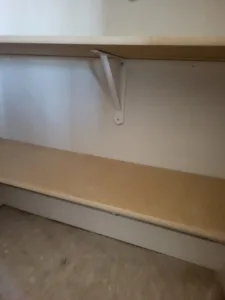Closet shelf with a support bracket and bullnose edge, raw wood ready for paint