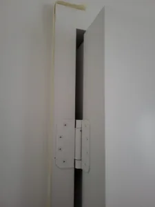 Door slab partially open with the jamb and casing installed around the opening