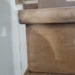 Wooden handrail with rounded profile, raw wood finish ready for stain or paint.
