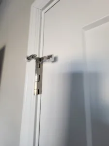 Painted white interior door with hardware installed near the jamb
