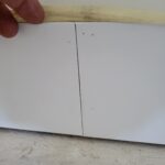 Baseboard seam detail showing joint between two painted sections meeting at floor level. (Wrong Way)