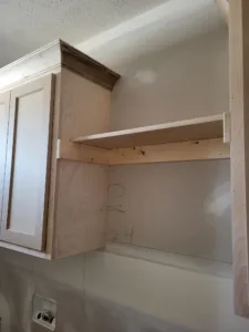Unfinished closet shelf with particle board bullnose top and raw plywood sides, ready for paint
