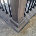 This photo shows a detailed view of a finished skirt board installation at the base of a newel post, highlighting craftsmanship and joinery.