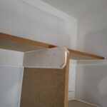 Installed closet shelves with bullnose particle board and wood edge banding, white face frame casing.