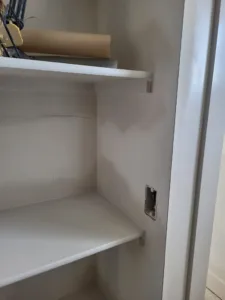 White closet shelving with two shelves and a bullnose front edge installed
