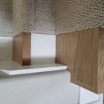 Face-frame closet shelving units with wood-grain front frames and white bullnose shelves installed in row.