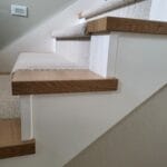 This photo shows a finished staircase with wood nosing installed on the edges, providing a clean and polished look to the steps.