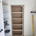 Custom built-in bookcase with five shelves and finished face frame, raw wood ready for paint.