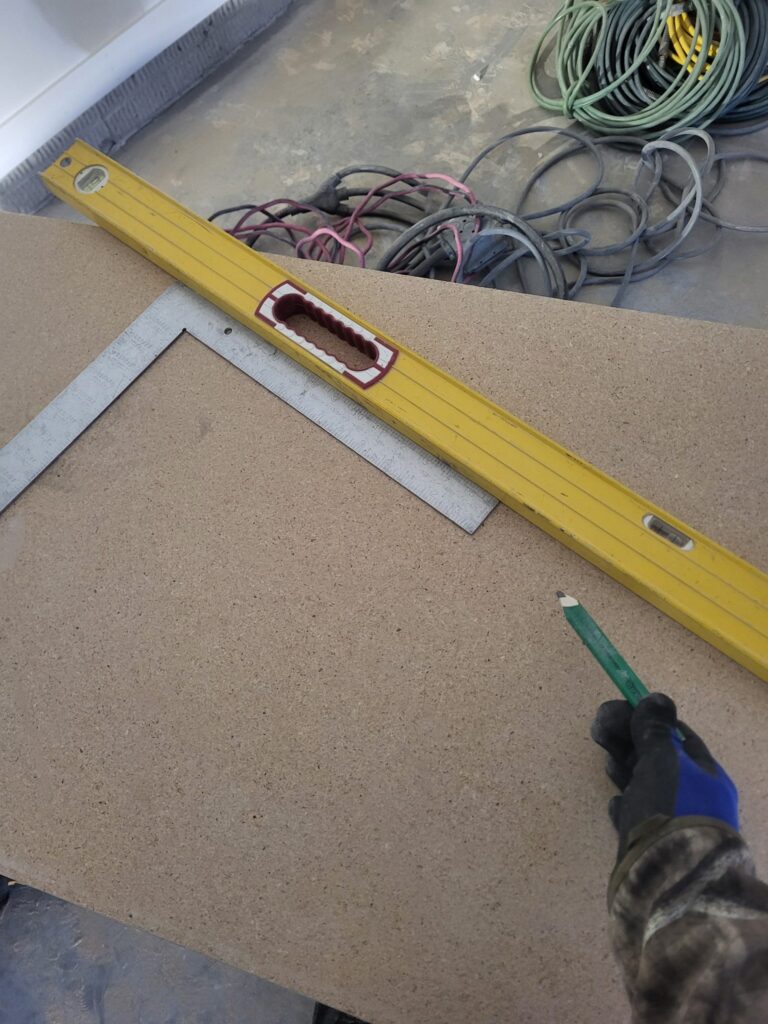 Level and square on a work surface beside a carpenter.