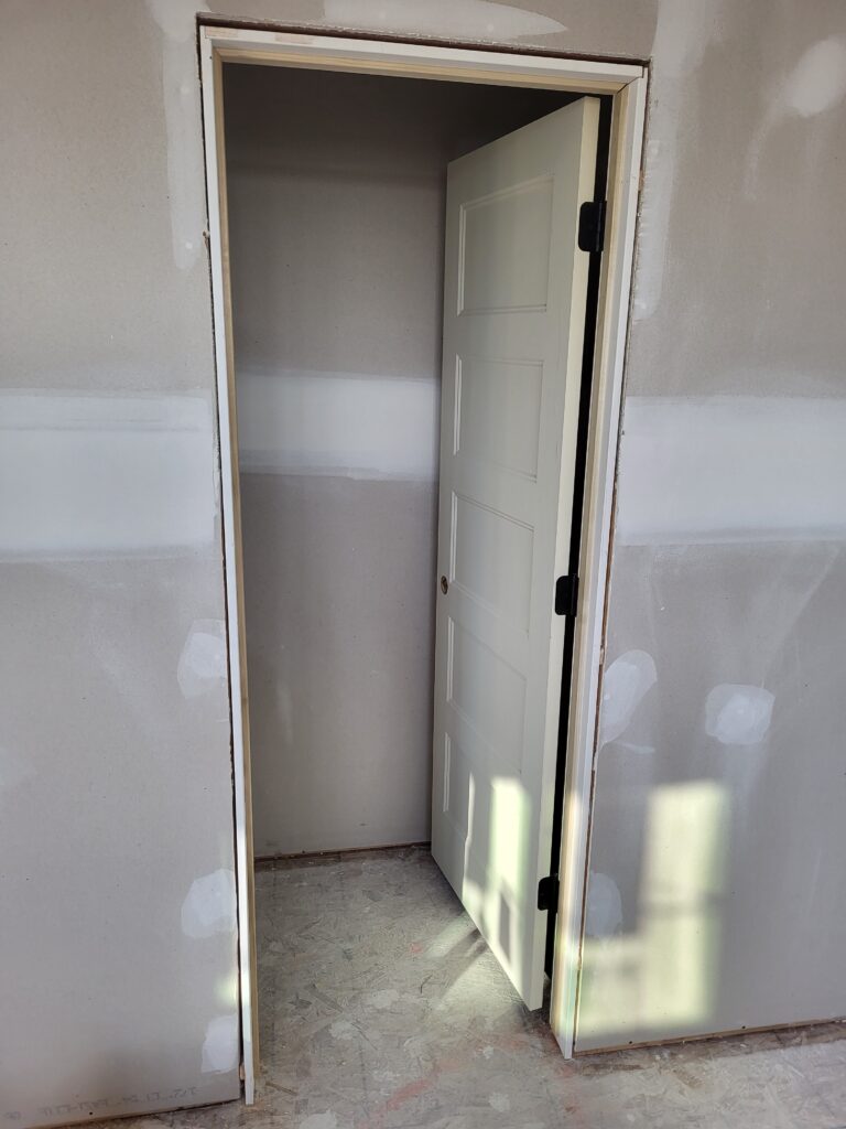 Six-panel interior pre-hung door hung plumb in its jamb