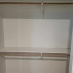 Two-tier closet shelving with bullnose particle board shelves and wood support cleats, ready for paint.