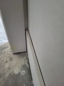 Incorrect: visible gap and shadow line where two surfaces meet at a wall corner.