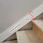 This photo shows the installation of skirt boards along the staircase, highlighting the precise measurements and alignment during the work process.