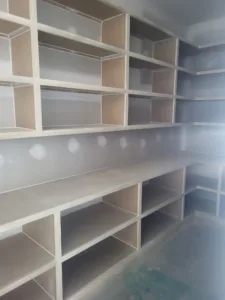 Unfinished closet shelving with face frame cubbies, raw wood ready for paint