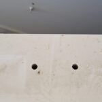 Barn door frame backer board with mounting holes drilled for track installation.