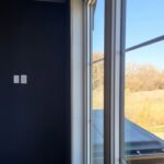 Large modern window installation with metal frame and mullions, interior trim complete and ready for paint.